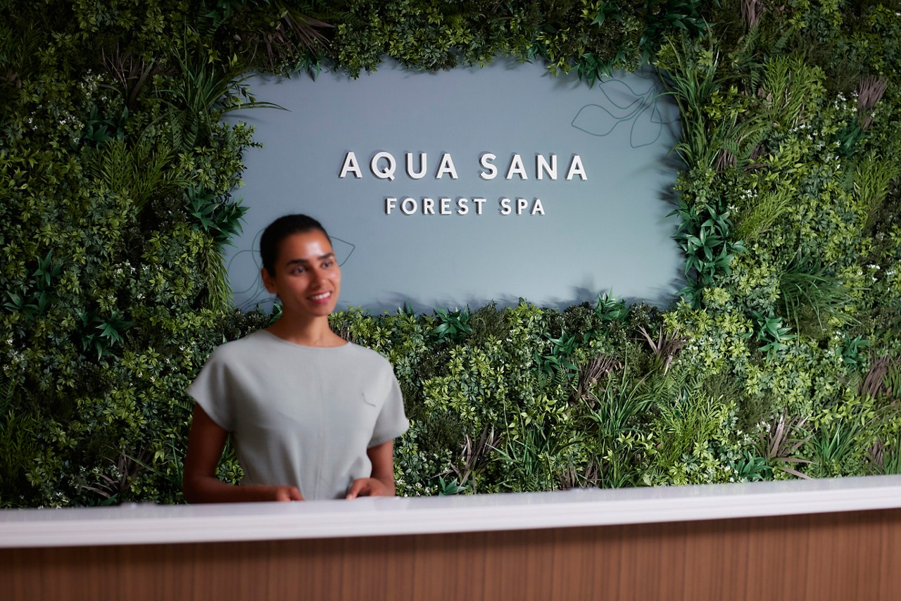 Staff member stood at the reception of Aqua Sana Forest Spa.